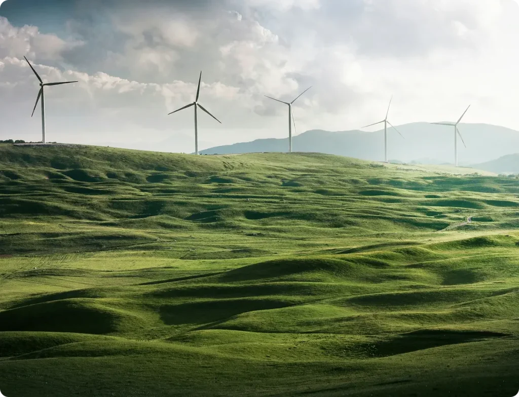 Big green fields with windmills and a bright sky