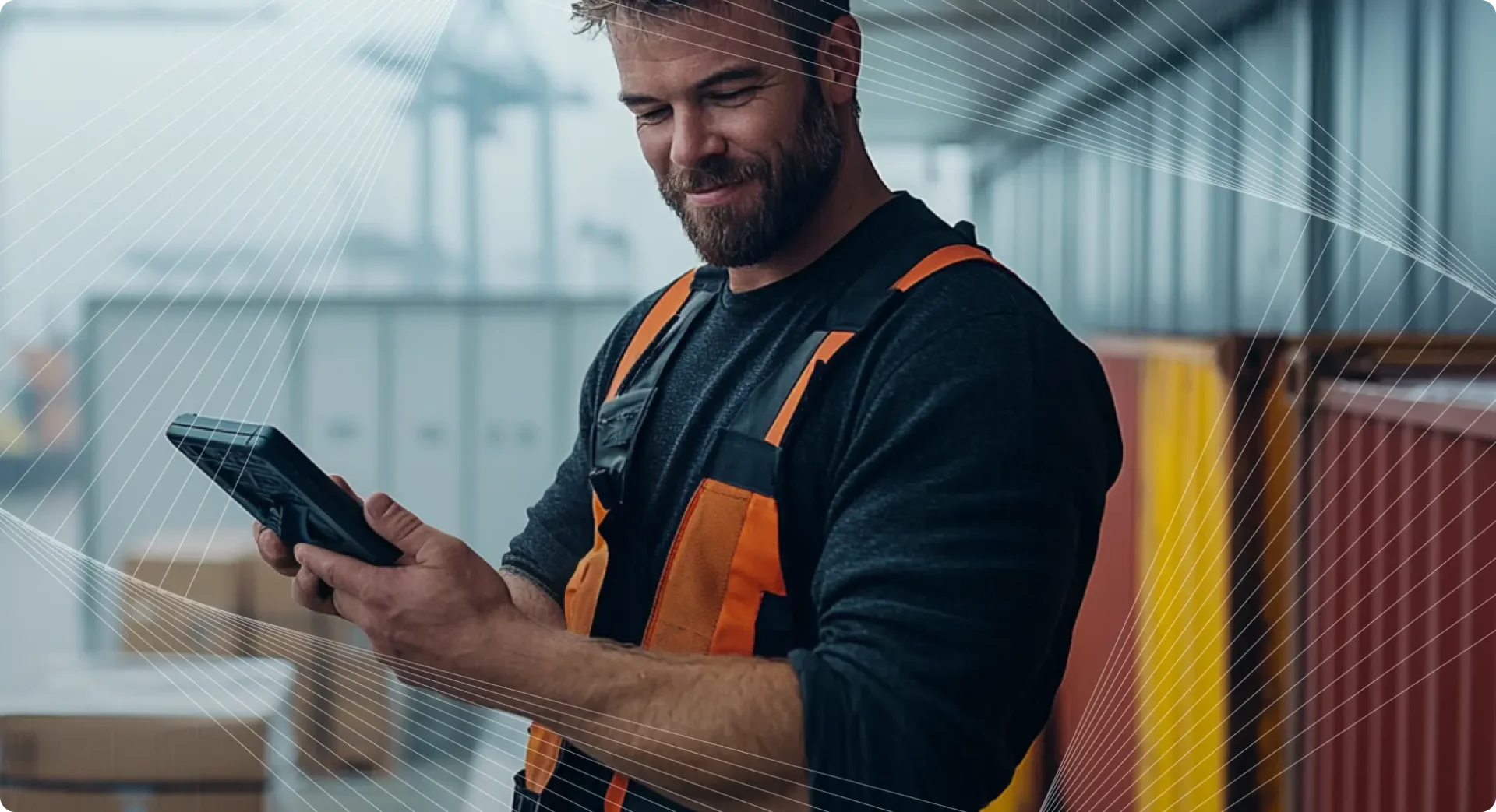 Man in workwear clothes with a technology device in his hands.